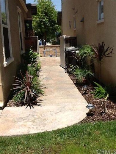 Backyard side view leading to front courtyard. 