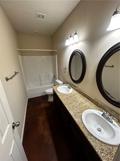 Bathroom with tub / shower combination, concrete f
