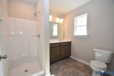Bathroom with double vanity and a shower stall