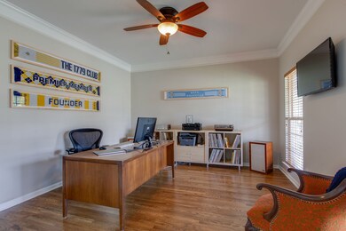Again those gorgeous floors! Note the crown molding and double windows overlooking the covered porch and the lush front yard. Truly a room with a view.