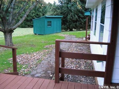 Exterior Back. Shed and stairs to small deck.