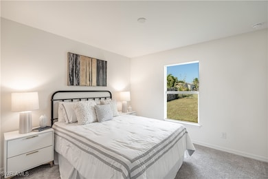 Carpeted bedroom featuring baseboards