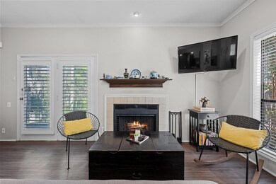Living room with a tiled fireplace, baseboards, o