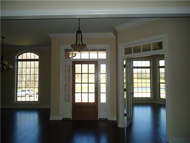 This is a view of the foyer from the living room. This home is very open and bright with the formal dining room to the left and the office/4th bedroom to the right.  