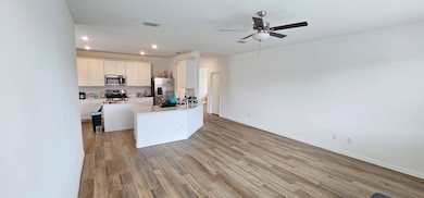 Kitchen featuring visible vents, decorative backsp