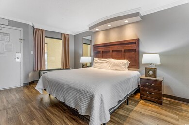 Bedroom featuring crown molding, wood finished floors, and recessed lighting