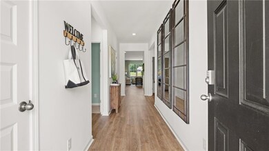 Hall featuring light wood-style floors and recessed lighting