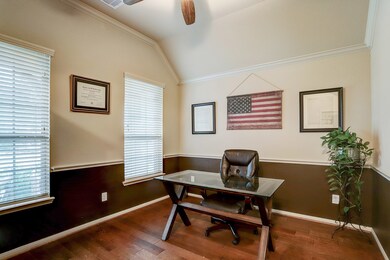 Formal dining room, currently used as a home office, with high ceilings, crown molding, and chair rail