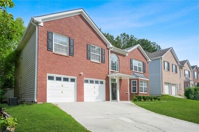 View of front of home with concrete driveway, a ga
