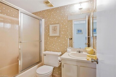 Full bathroom with tiled walls, shower / bath comb