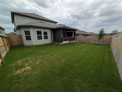 Rear view of house featuring a fenced backyard an