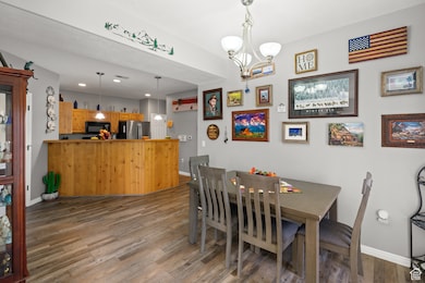 Dining space with light wood-type flooring and a chandelier
