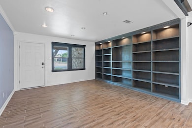 Spare room with ornamental molding, baseboards, w
