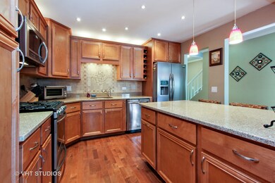 Kitchen with granite counters built in wine rack.