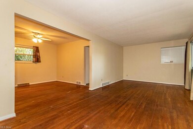 Wood floored empty room with ceiling fan