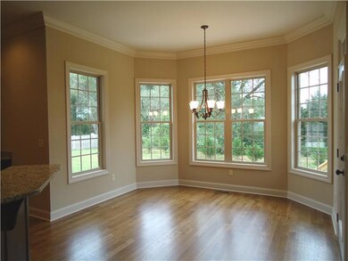 The breakfast room is convenient to the kitchen and living room. With beautiful bay window views and a door leading to the deck, it is the perfect place for morning coffee.
