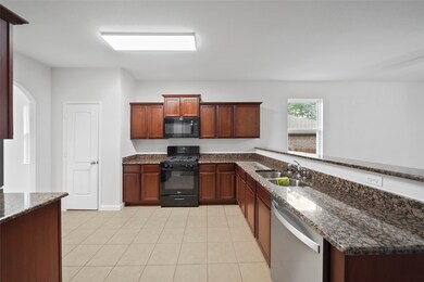 Spacious kitchen with microwave & gas range.