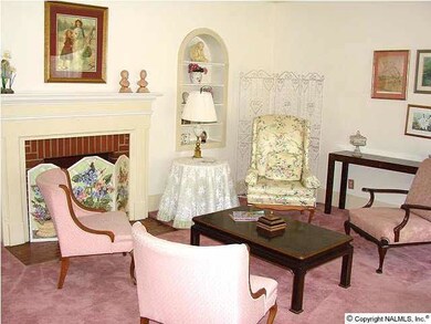 Living room features arched built-in's and a gas log fireplace.