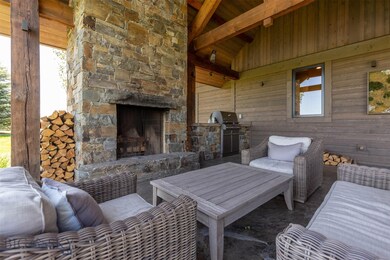 Outdoor covered patio with wood burning fireplace