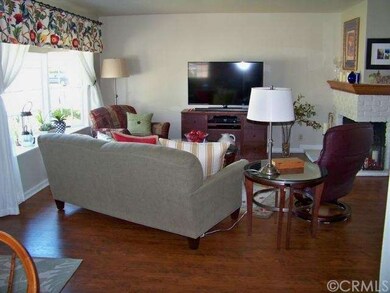 Living Room with Bay Window and Corner Fireplace