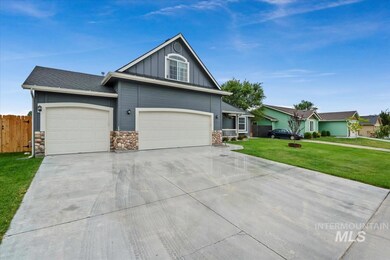 View of front of property featuring driveway, an attached garage, board and batten siding, stone siding, and roof with shingles