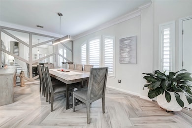The dining area exudes modern elegance, highlighte