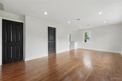 Unfurnished room featuring wood finished floors, r