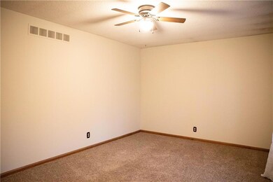 Unfurnished room with carpet, a textured ceiling, and ceiling fan