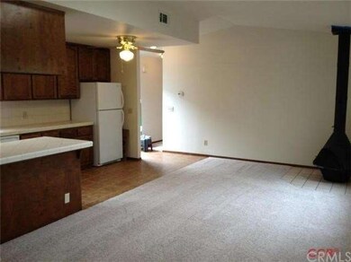 Living area has a wood burning freestanding stove.