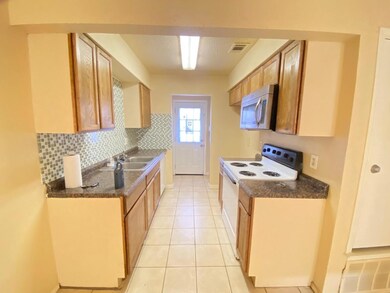 Kitchen featuring stainless steel microwave, a sin