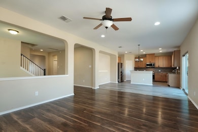 Unfurnished living room featuring ceiling fan, da