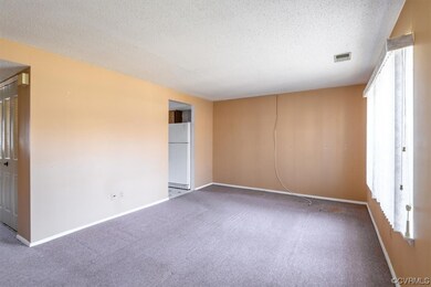 Living room view into the hallway and the entry in