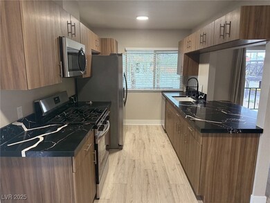 Kitchen with stainless steel appliances, dark coun