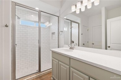 Full bath featuring a stall shower and vanity