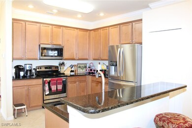 Kitchen with crown molding, dark stone countertops