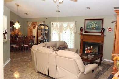 Living room with a fireplace and a ceiling fan
