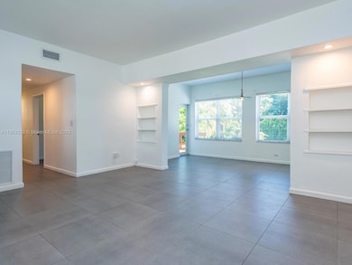Living room and dining room with recessed shelves and lighting - high 9' ceilings - lots of glass all impact windows