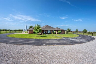 Single story home with driveway, brick siding, and a shingled roof