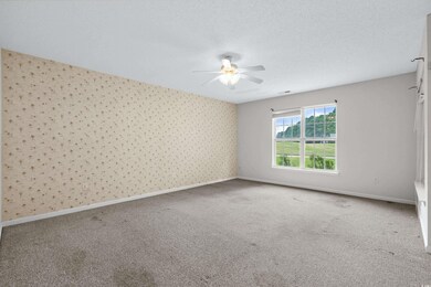 Spare room with a textured ceiling, carpet floors,
