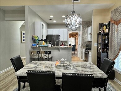 Dining area featuring light wood finished floors, a chandelier, and recessed lighting