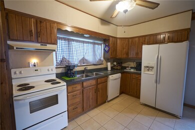 Kitchen with enough room for a small table and ple