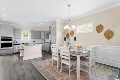 Dining room featuring a chandelier, dark wood-type