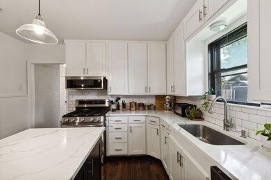 Kitchen with decorative backsplash and white cabin