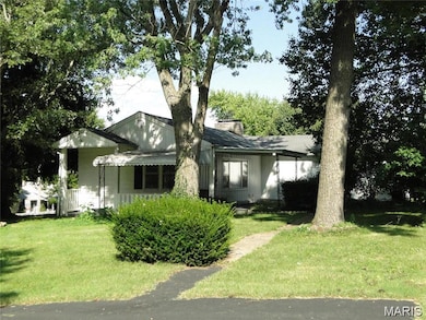 View of front of house featuring a front lawn and a chimney