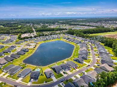 Birds eye view of property with a water view