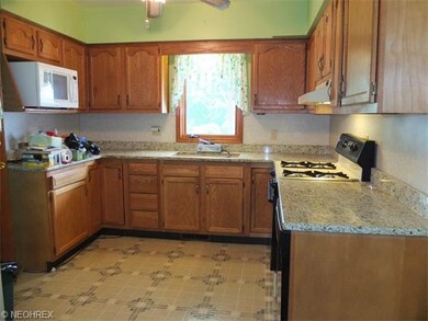 Fully applianced kitchen with granite countertops.