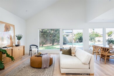 Living room #1 with oversized windows and glass sliding door to backyard.