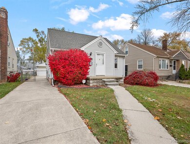 View of front of house with a gate and a shingled roof