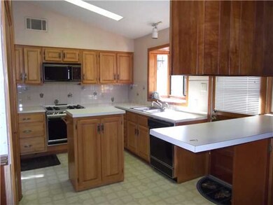 Extra storage in island that rolls back &fits unde