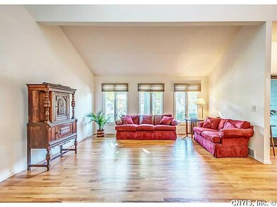 Living Room. Floor to ceiling windows, and cathedr